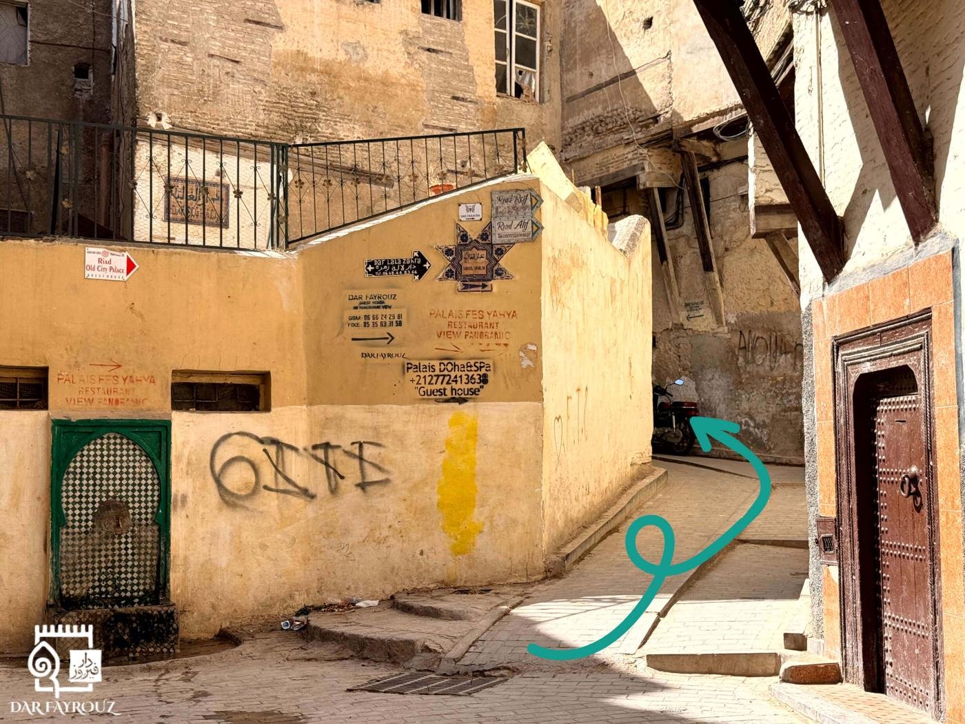 The yellow wall with the Dar Fayrouz sign and the lane on its right