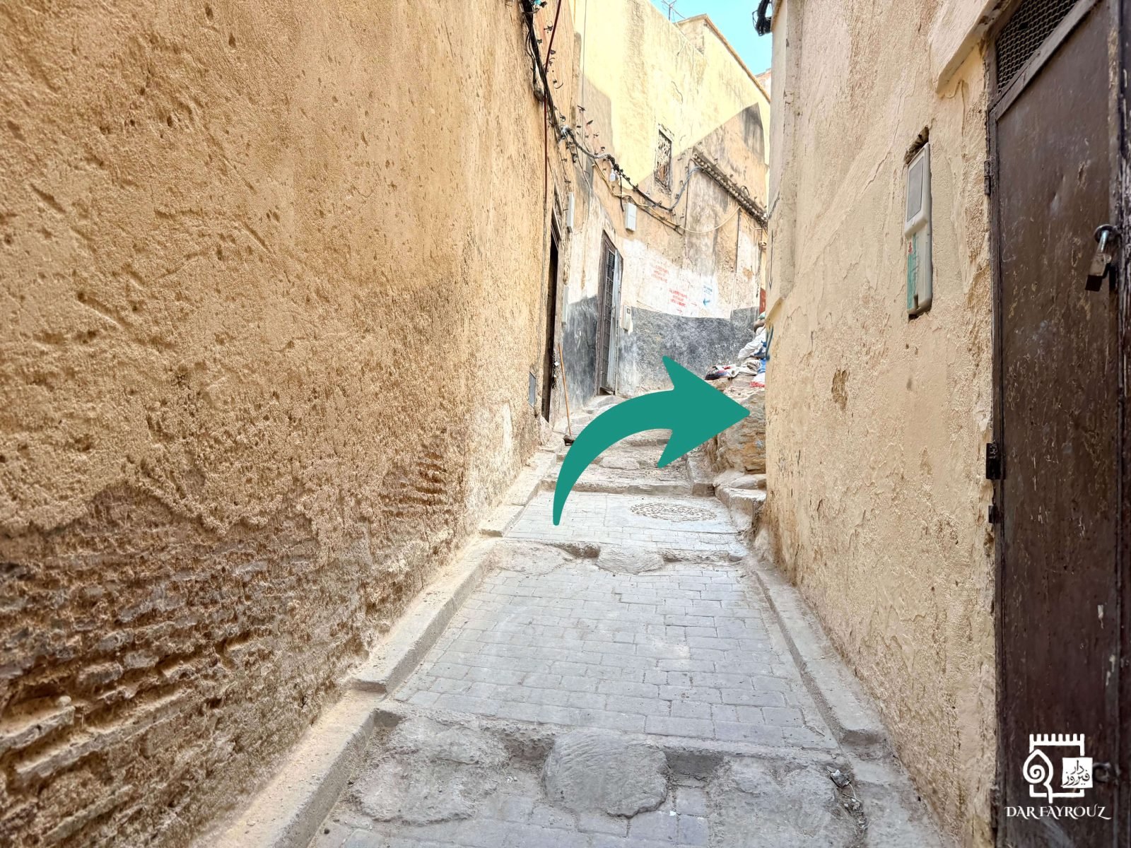 A narrow paved lane rising over a small step, bending to the right