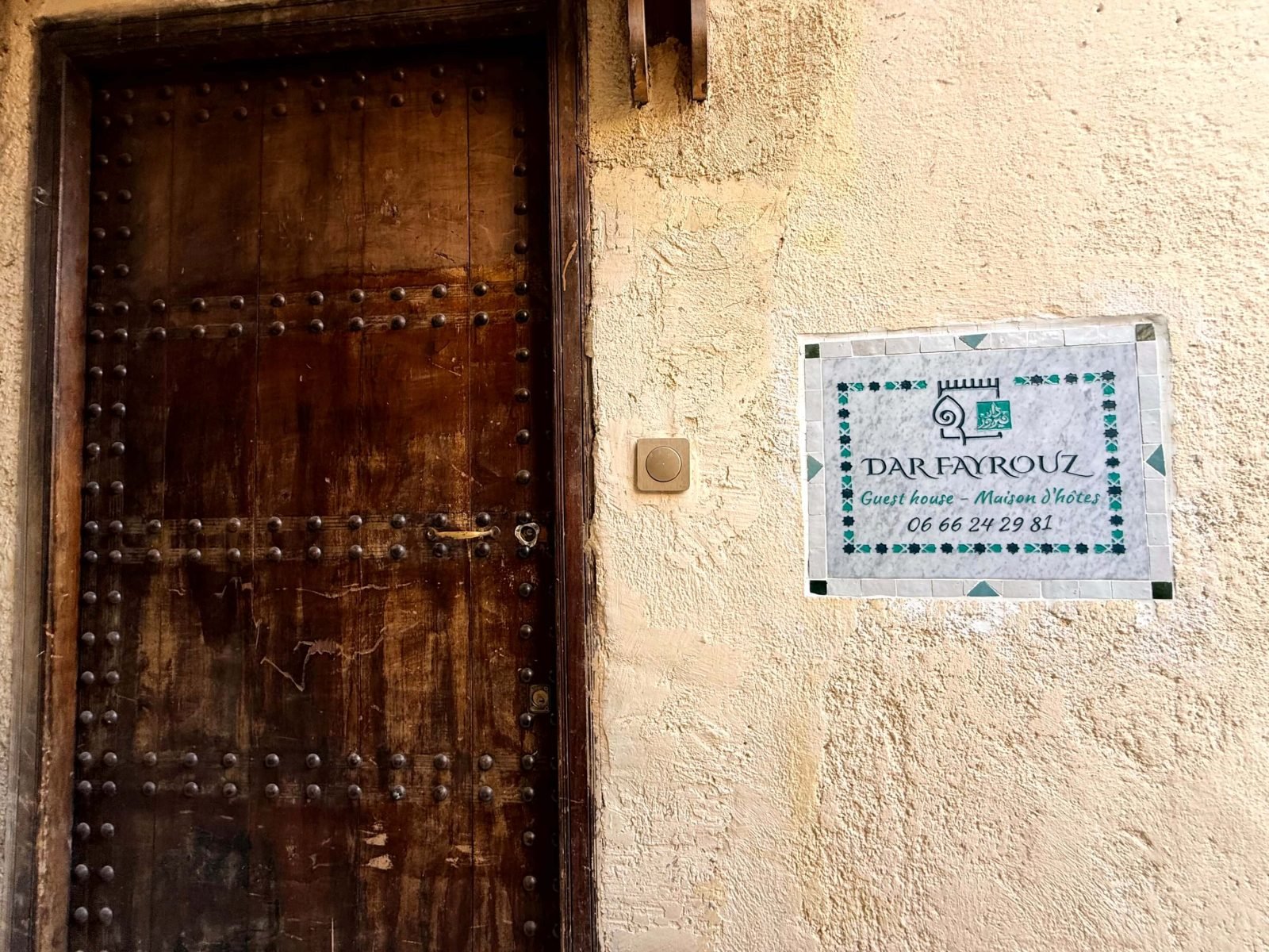 The front door of Dar Fayrouz with the doorbell and the marble sign