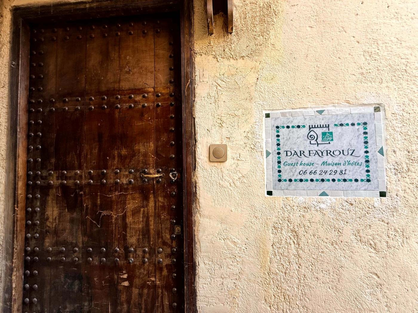 The front door of Dar Fayrouz with the doorbell and the marble sign